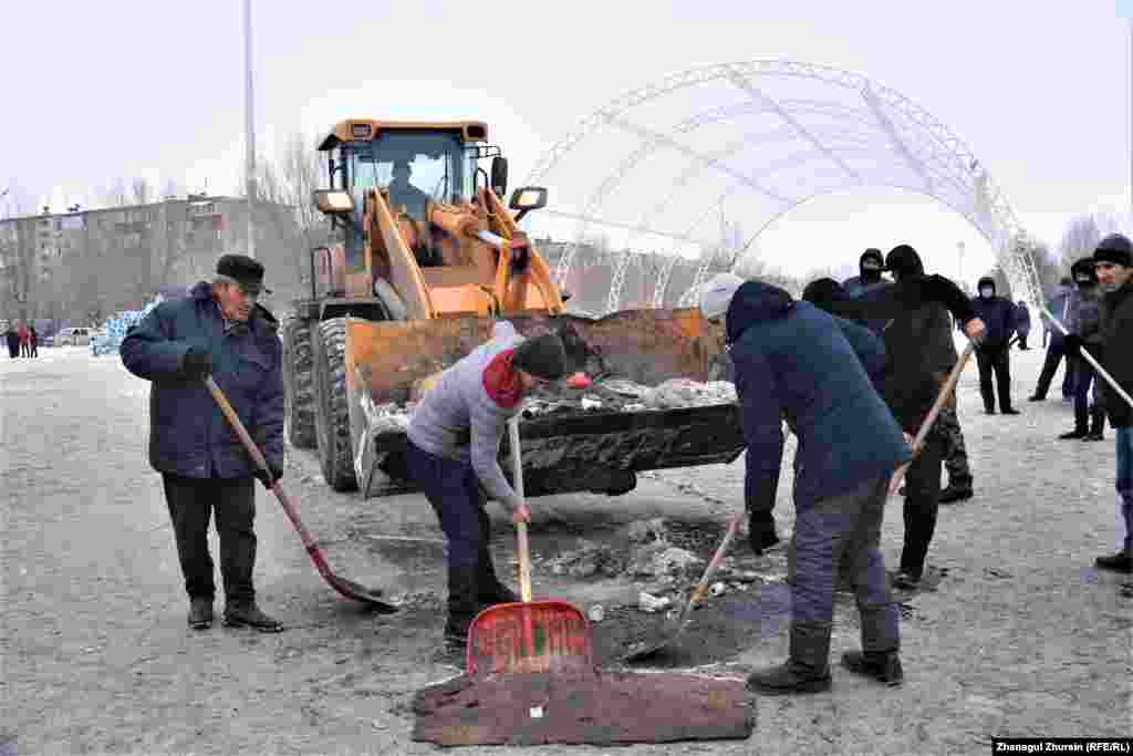 Ақтөбедегі бейбіт наразылық акциясы өтіп жатқан алаңды тазалап жүрген еріктілер.&nbsp;Ақтөбе, 6 қаңтар 2022 ж.