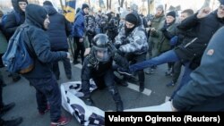 UKRAINE -- Activists of Ukrainian far-right movements attack police officers during a protest of agricultural workers against land reform in Kyiv, December 17, 2019