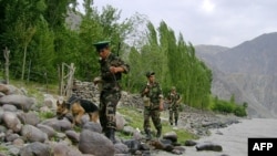 Tajikistan -- Tajik border guards patrolling the Tajik-Afghan border on the Panj River banks outside the city of Panj, Aug2010