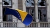 Bosnia-Herzegovina -- A Bosnian and Herzegovina national flag is seen on a damaged government building in Sarajevo February 8, 2014.