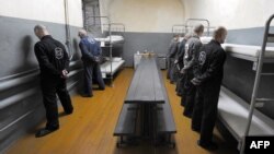 Belarus -- Inmates with life sentences stand at attention facing the walls of their prison cell in expectance of a security guard inside a prison in Glubokoye, 23Jul2009 