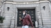  man wears a protective face mask as he walks past Banco de Espana (Bank of Spain), amidst concerns over coronavirus outbreak, in Barcelona, Spain March 14, 2020. 