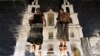 Belarus -- Two women walking in front of Svyato-Dukhov (Holy Spirit ) Orthodox cathedral are reflected in the wet tablets of a roadway in the capital Minsk, July 20, 2014