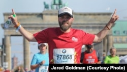 Jared Goldman finishing marathon in Berlin