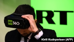 RUSSIA -- A man tries on a VR goggles at the stand of Russia's state-controlled broadcaster RT during the 10th Russian Internet Week in Moscow, November 1, 2017